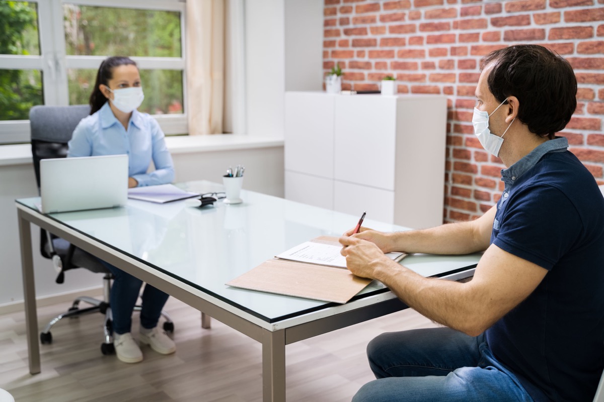 Job Interview Business Meeting At Law Office Wearing Face Mask; protect workers concept.