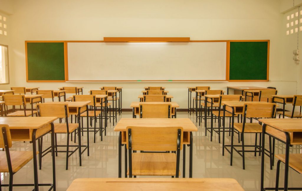 Lecture room or School empty classroom with desks and chair iron wood for studying lessons in high school thailand, interior of secondary education, with whiteboard, vintage tone educational concept