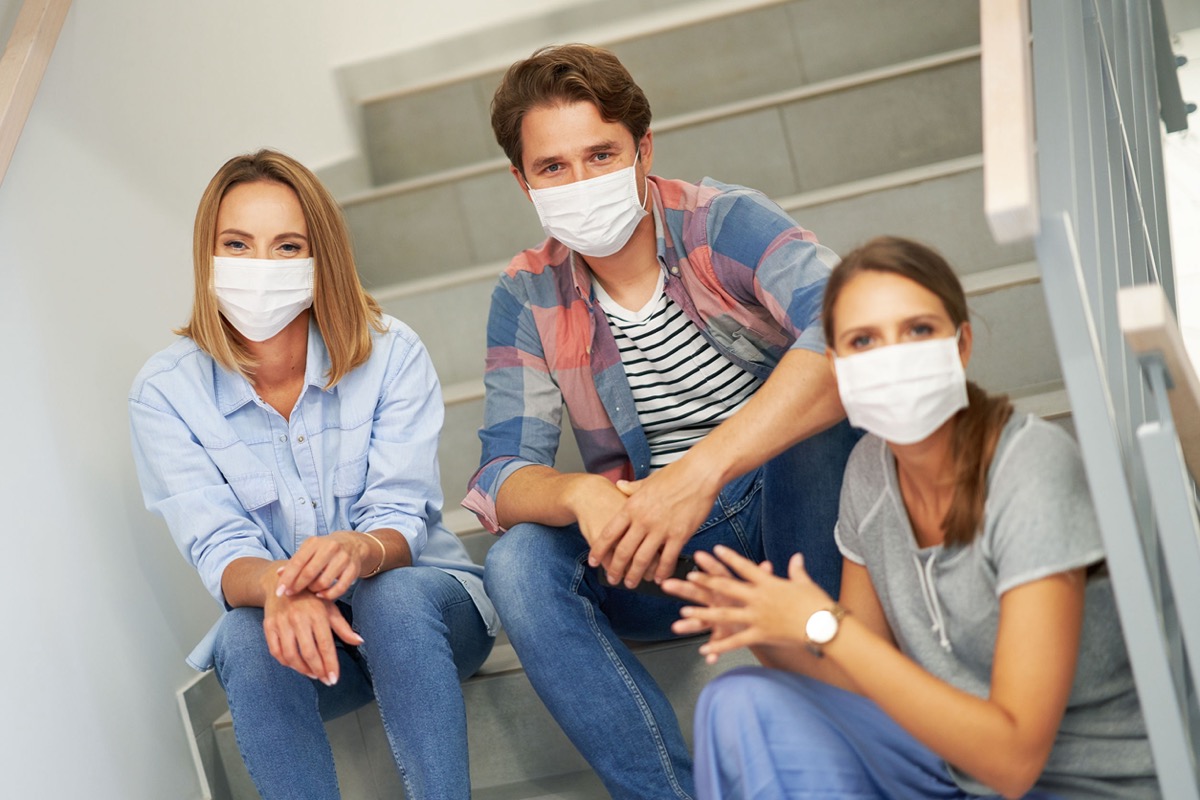 Picture of students wearing masks in the campus; university workers concept