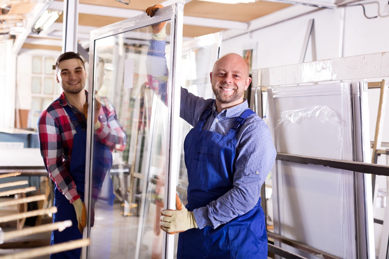 two window installers holding a large plate glass; IUPAT supports workers concept