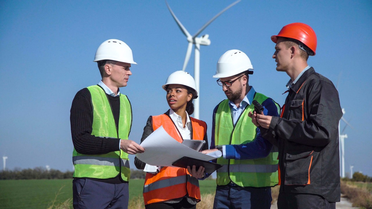 four construction workers discuss plans; American jobs plan and labor interests concept