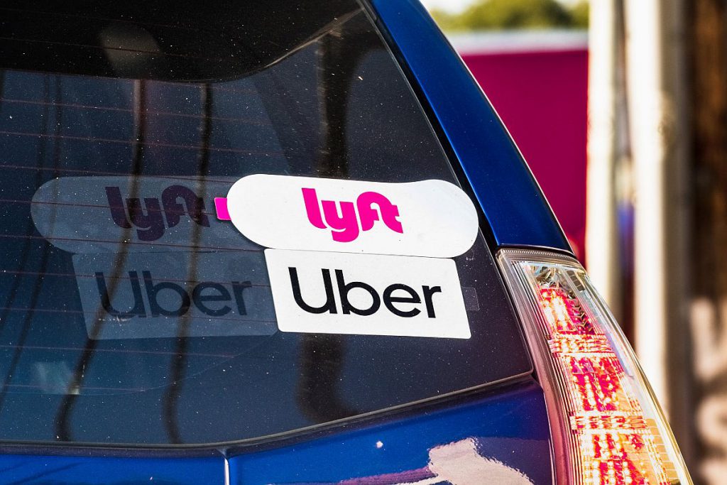 Oct 10, 2019 Mountain View / CA / USA - Lyft and UBER stickers on the rear window of a vehicle offering rides in San Francisco Bay Area